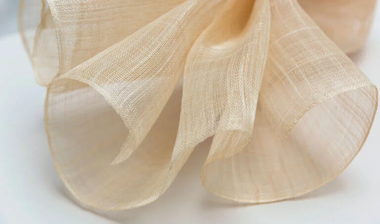 Abaca fishnet fabric sample beside the Why Choose Us section